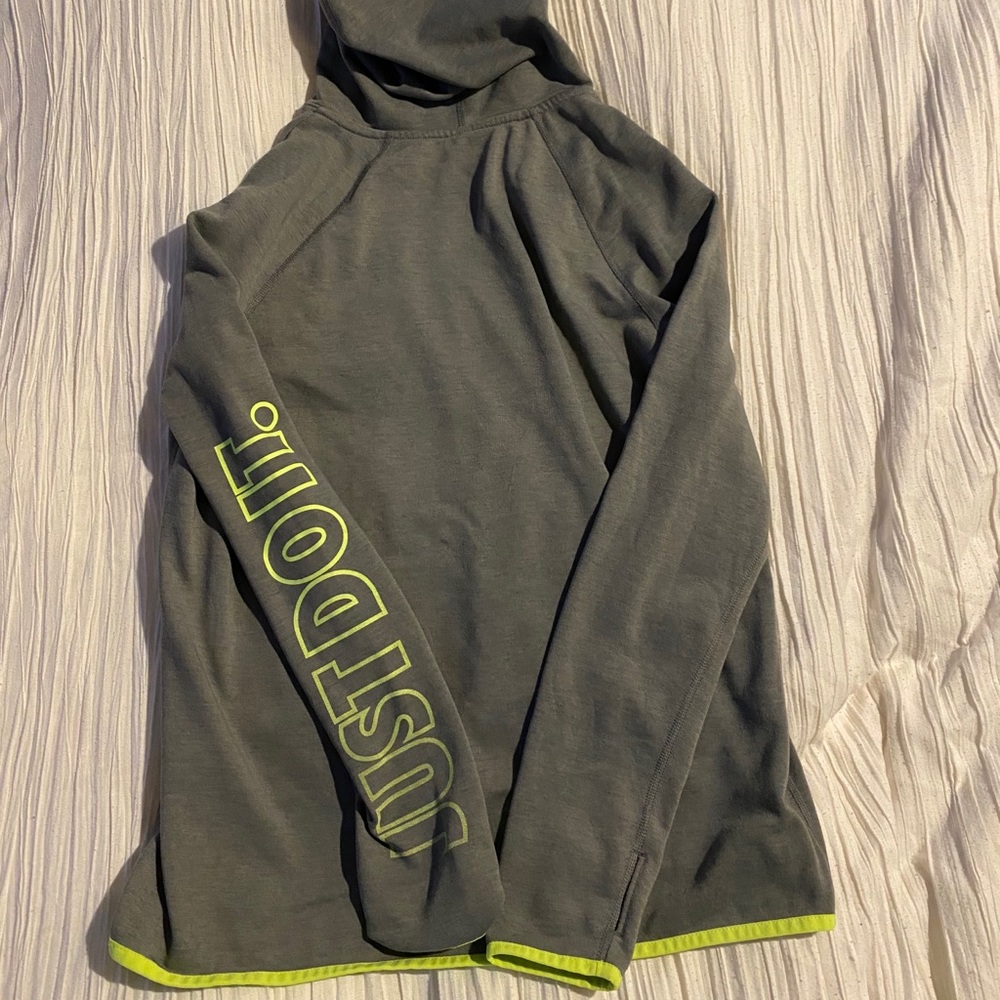 I am selling this grey and green Nike hoodie.